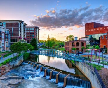 Downtown Greenville SC at sunset with waterfall and bridge