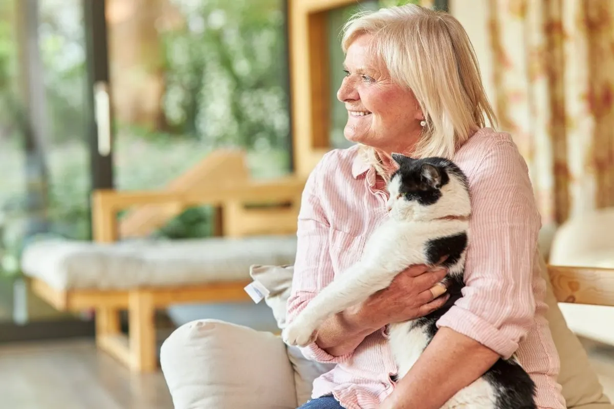 senior woman holding therapy cat